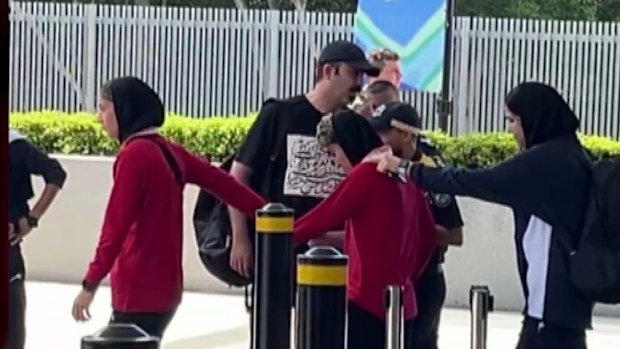 Protesters have tried to block a bus taking the Iranian women's football team from their hotel on the Gold Coast to the airport and out of Australia after five members of the side who escaped their handlers were granted asylum by the federal government. Members of the team appeared to pull one player towards the bus as the team left the RACV Royal Pines Resort this afternoon.