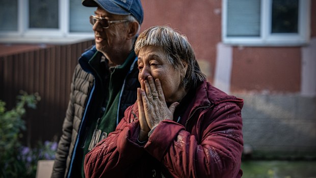 A woman reacts after receiving an aid package from a Christian charity in Bakhmut, Donetsk oblast, Ukraine. 