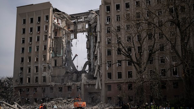 Emergency personnel work at the site of the regional government headquarters of Mykolaiv, Ukraine, following a deadly Russian attack.