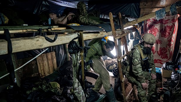 Ukrainian paratroopers of 80 Air Assault brigade rest inside a dugout at the frontline near Bakhmut, Ukraine.