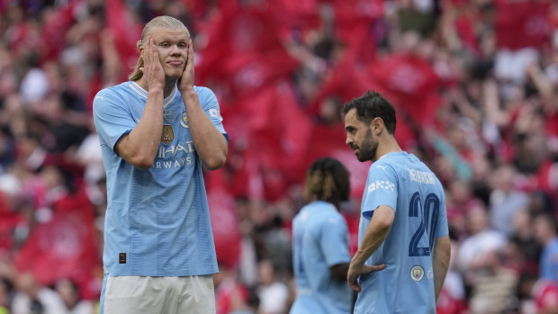 Manchester City's Erling Haaland, left, and Manchester City's Bernardo Silva react at the end of the English FA Cup final soccer match between Manchester City and Manchester United at Wembley Stadium in London, Saturday, May 25, 2024. Manchester United won 2-1. (AP Photo/Kin Cheung)