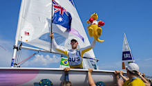 Matthew Wearn of Australia jubilates after winning the gold medal at the end of the ILCA 7 men's dinghy class final race during the 2024 Summer Olympics, Wednesday, Aug. 7, 2024, in Marseille, France. (AP Photo/Jacquelyn Martin)