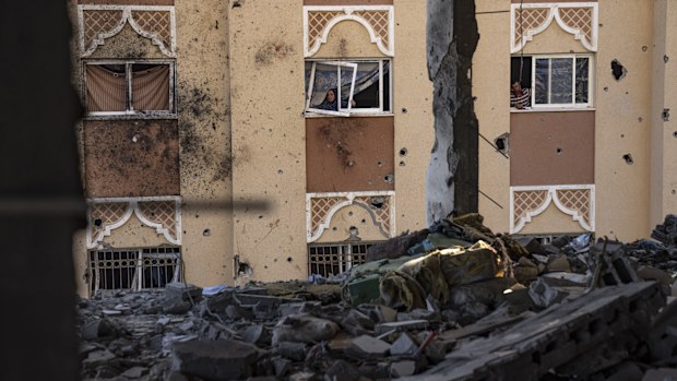 Palestinians look at destruction after an Israeli strike on the Gaza Strip in Khan Younis