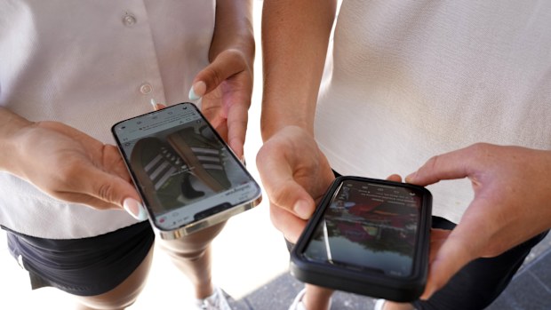 Two young teenagers use their phones to view social media