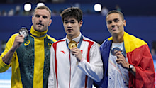 Gold medalist Pan Zhanle, of China, poses with silver medalist Kyle Chalmers, of Australia, left, and bronze medalist David Popovici, of Romania, right, after the men's 100-meter freestyle final at the 2024 Summer Olympics, Wednesday, July 31, 2024, in Nanterre, France. (AP Photo/Ashley Landis)