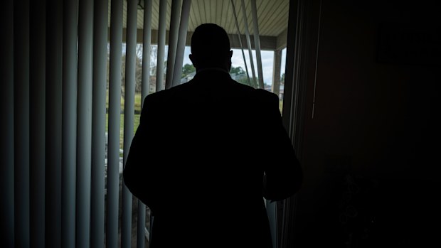 Joseph Moore looks out of a window at his home in Jacksonville, Florida.