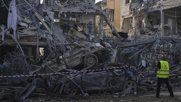 Israeli security forces inspect destroyed residential buildings that were hit by a missile fired from Iran, in Ramat Gan, near Tel Aviv, Israel, on Saturday, June 14, 2025. (AP Photo/Ariel Schalit)
