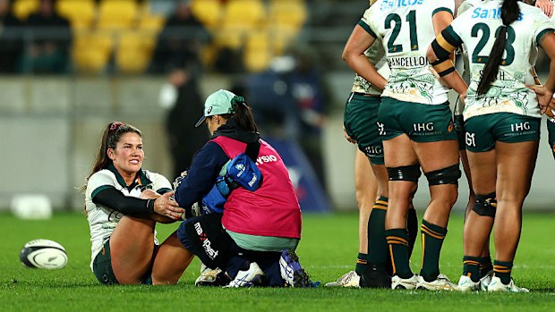 Charlotte Caslick of Australia receives medical attention at Sky Stadium in Wellington.