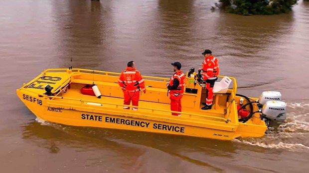 An SES boat patrols the Hunter River near Hinton.