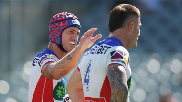 Kalyn Ponga of the Knights celebrates scoring a try with team mate Bradman Best.