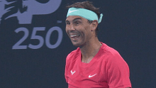 Rafael Nadal laughs after being given a time violation for taking too long at the toilet.