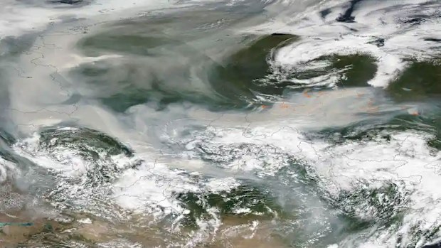 An image released by Nasa shows smoke from hundreds of forest fires covering most of Russia.