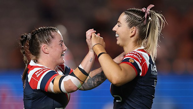 Jayme Fressard of the Roosters celebrates a try with Jocelyn Kelleher.