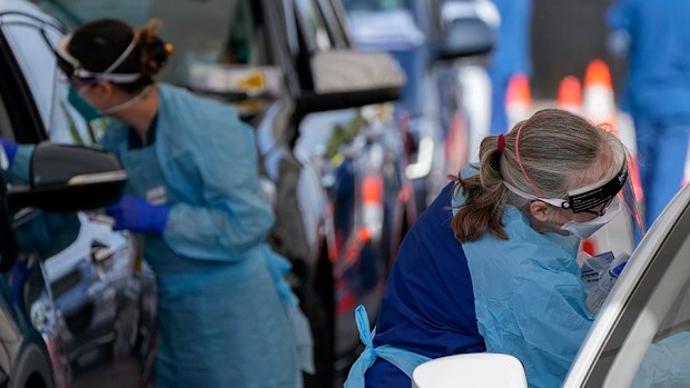 Staff collect samples at a drive-through COVID-19 testing clinic at Bondi Beach.