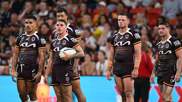 Broncos players react after the Panthers scored a try.