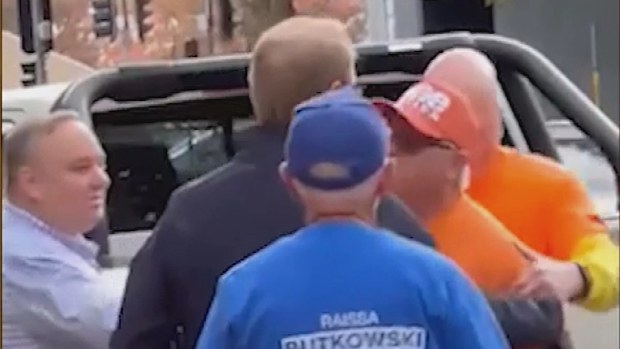 James Paterson, in the navy jacket, and the One Nation volunteer, clash at the polling booth in Albury.