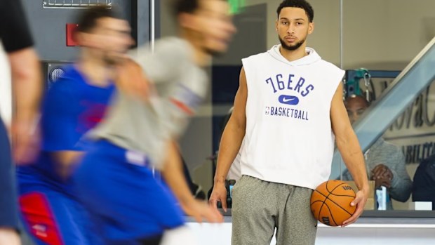 Ben Simmons shows up to 76ers training in tracksuit pants, with a phone in his pocket.