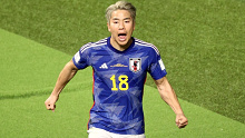 Takuma Asano celebrates after scoring for Japan against Germany. 