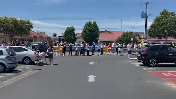 People lining up outside a supermarket in Adelaide.