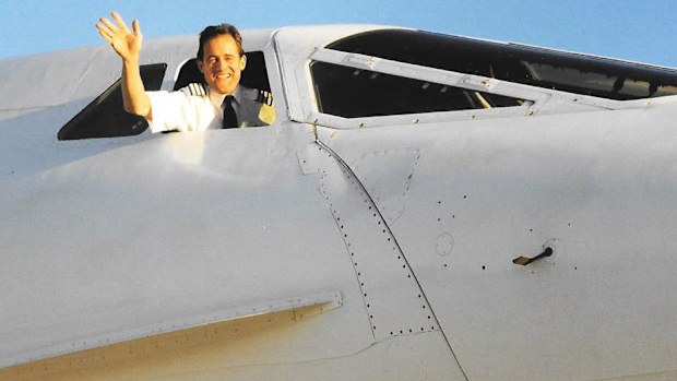 Concorde pilot John Tye waves out the window.