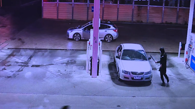 Two males are on the run after a teenager was slashed with a machete while he was refuelling at a service station in Melbourne.