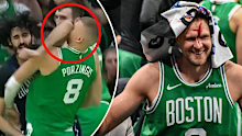 Kristaps Porzingis smiles after being bloodied in the playoffs.