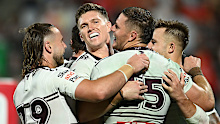 Corey Waddell celebrates with teammates after scoring a try.