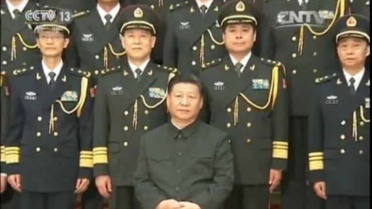 Chinese President Xi Jinping (seated) with Lieutenant-General Yang Xuejun (second from right, front row). 