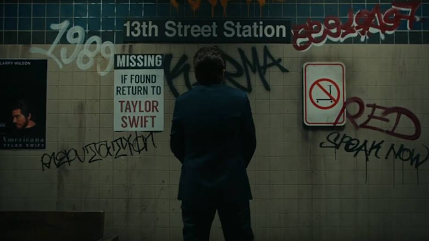 Taylor Swift's album names are graffitied on the wall.