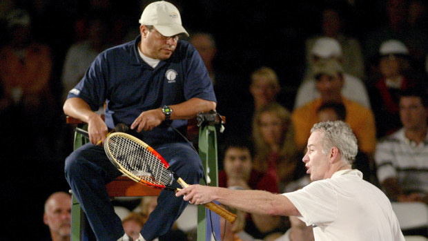 John McEnroe argues with an umpire. (Getty)