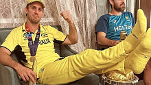 Mitchell Marsh with his feet resting on the World Cup trophy after Australia's victory over India.