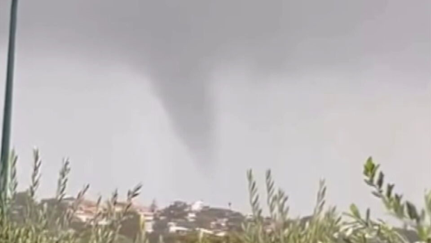 A clean-up is under way across parts of Perth after a suspected tornado ripped through suburbs, uprooted trees and triggered flash flooding.
