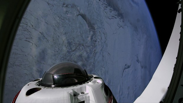 This photo provided by SpaceX shows the domed window of the Dragon capsule with a polar region of the Earth in the background on Tuesday, April 1, 2025. (SpaceX via AP)