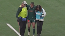 Kurtley Beale is helped off the field.