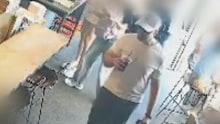 Ofir Birenbaum, wearing a white cap with the Star of David and video-equipped glasses, can be seen on CCTV from the cafe. 