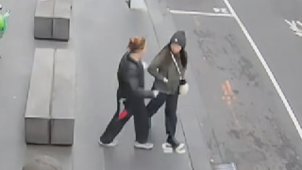 CCTV footage has shown the moment a woman was randomly stabbed in broad daylight while walking to work at a sushi restaurant in Melbourne's CBD. 