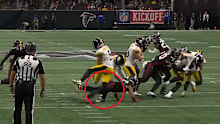 Cameron Johnston is cleaned up by a Falcons player.