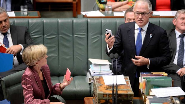 Mr Turnbull and Foreign Minister Julie Bishop brandish their phones in question time last year. (AAP)