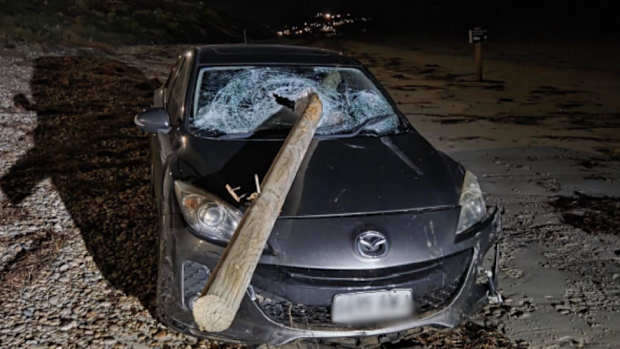 A Mazda had to be towed from a beach after an allegedly drunk driver crashed through a guard rail, careered down an embankment and ended up on the sand.
