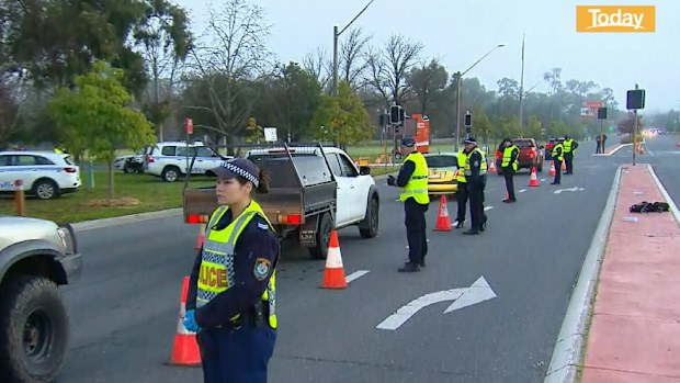 Police stop cars at the NSW-Victoria border.
