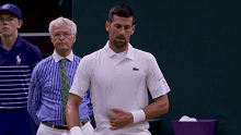 Djokovic clutches at abdominal muscle.