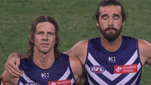 Fremantle players Nat Fyfe and Alex Pearce hold back tears as they pay tribute to their late teammate Cameron McCarthy.