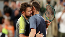 Stan Wawrinka of Switzerland and Andy Murray of Great Britain embrace at the net.