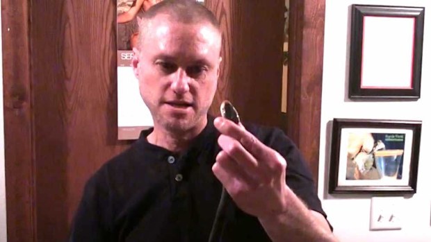 A screenshot of a video Tim Friede posted on YouTube 11 years ago of him being bitten by a taipan.