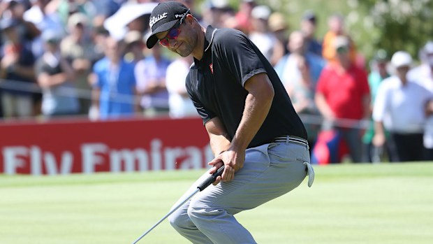 Adam Scott reacts after missing a putt. (AAP)