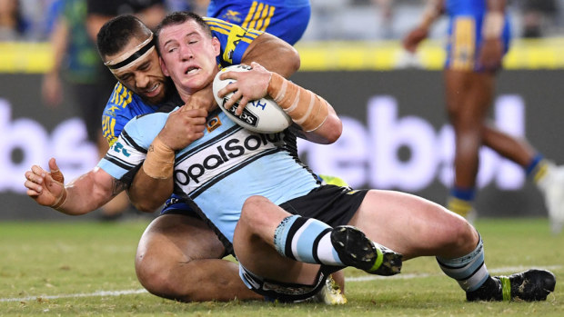 The Sharks' Paul Gallen wrestles with Susaia Matagi.