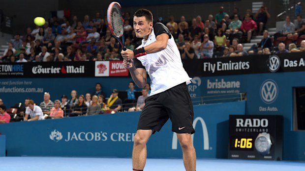 Bernard Tomic returns serve at the Brisbane International. (AAP)