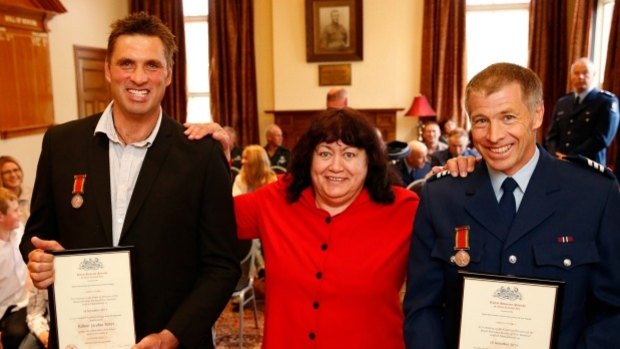 Robert Borst, left, and Peter Muldrew received bravery awards for saving Rhoda Davidson's life (centre).