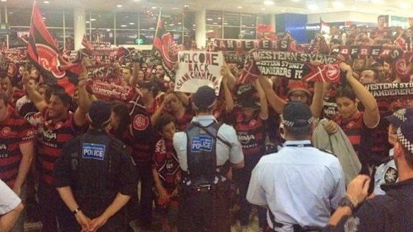 Proud bunch: Wanderers fans in the arrivals hall.