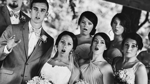 This wedding photographer managed to catch a perfectly timed shot during his backwards slip.